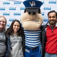 Group of alumni pose with Louie the Laker